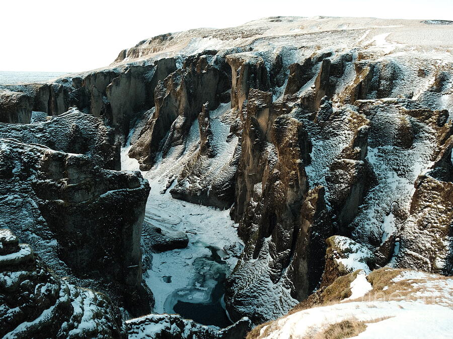Snow traces the edges of Fjaðrárgljúfur Canyon.